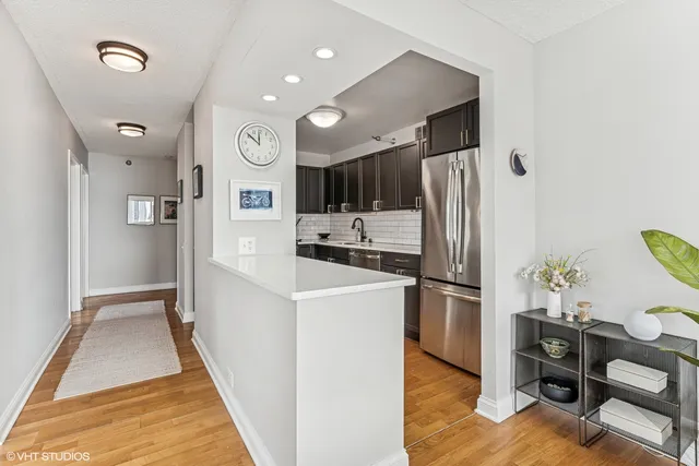 a kitchen with stainless steel appliances granite countertop a refrigerator and a stove top oven