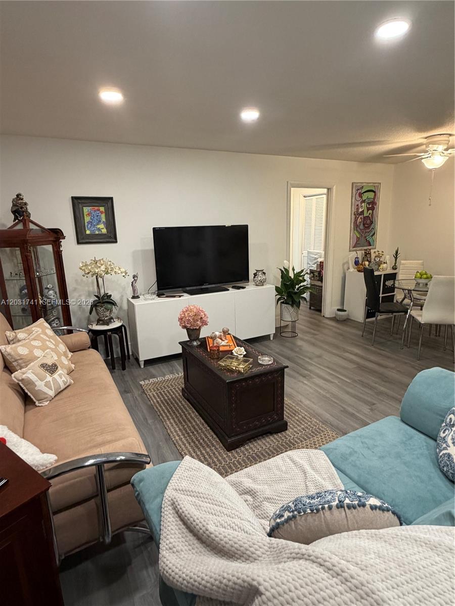 3500 Harrison Street, Unit 4 Hollywood, FL 33021 - Photo 4 of 10 a living room with furniture and a flat screen tv