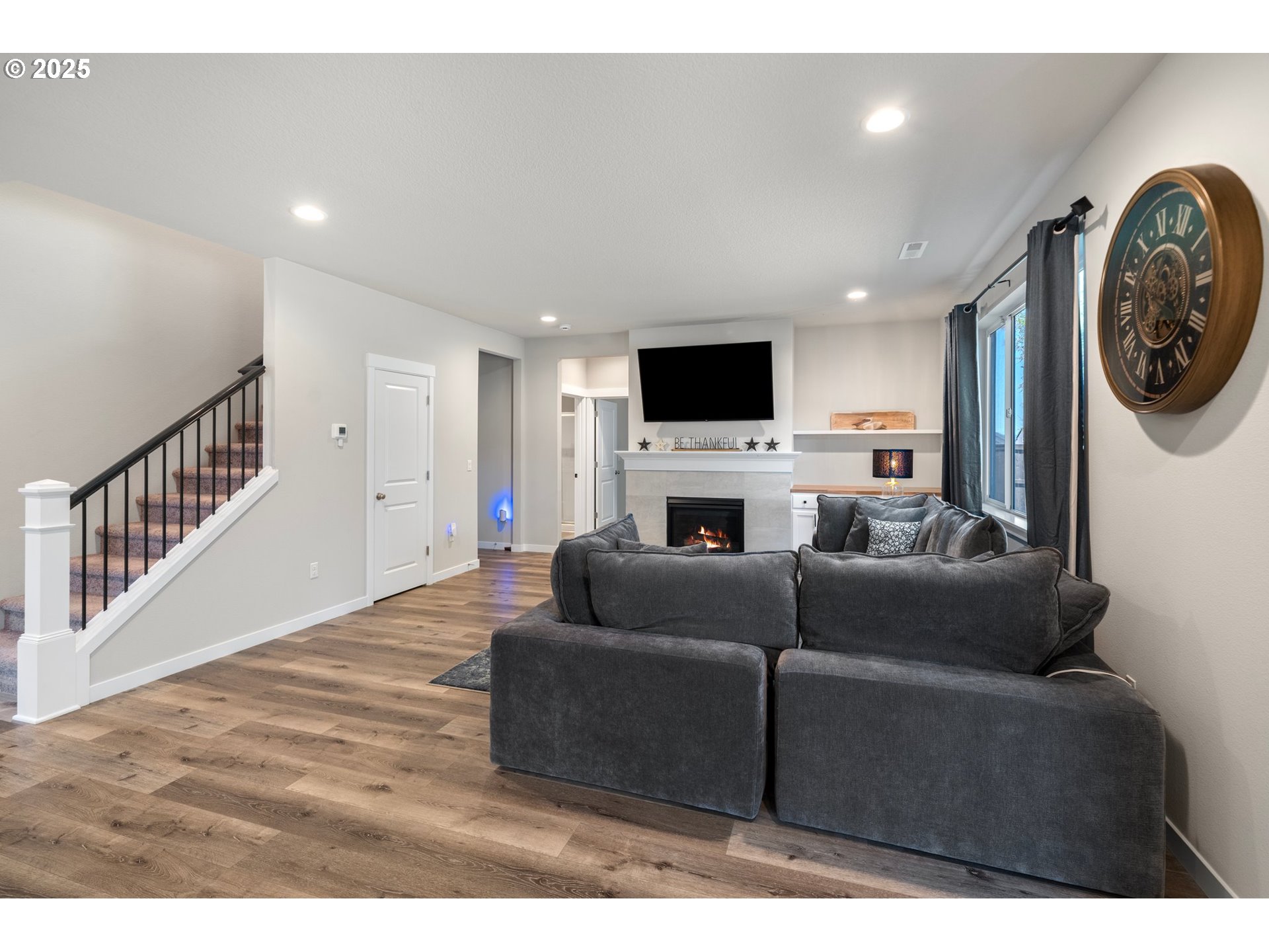 8852 North 5th Street Ridgefield, WA 98642 - Photo 6 of 47 a living room with furniture and a flat screen tv