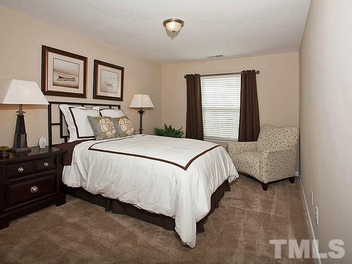 1007 Grand Ridge Drive Rolesville, NC 27571 - Photo 12 of 16 a bedroom with a bed and a night stand