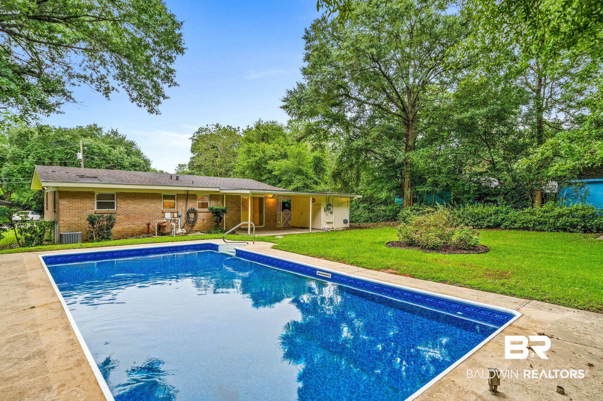 280 Thrift Street Mobile, AL 36609 - Photo 19 of 22 View of swimming pool with central AC and a lawn