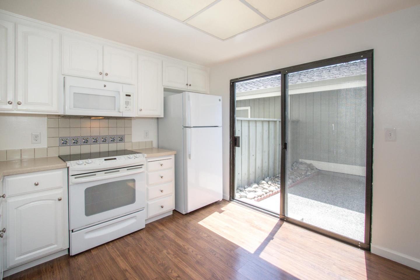 810 Juno Lane Foster City, CA 94404 - Photo 10 of 43 a kitchen with a refrigerator and a stove top oven