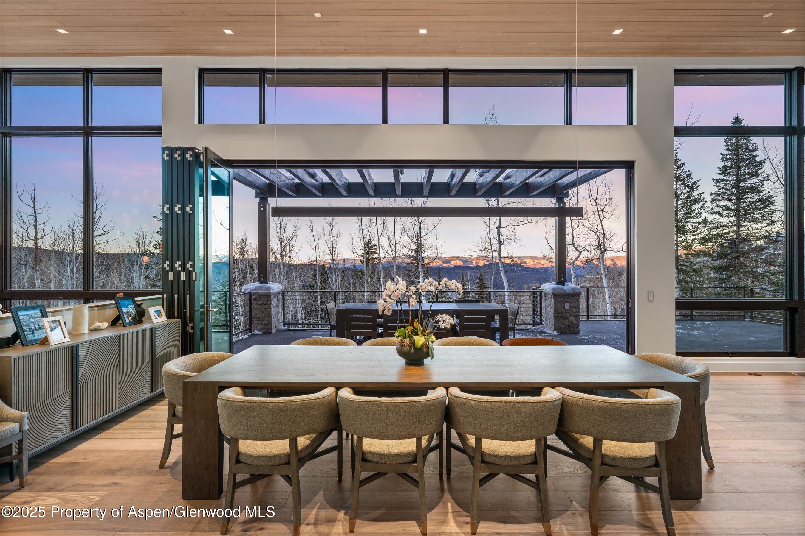 1234 Wood Road Snowmass Village, CO 81615 - Photo 60 of 66 a dining room with furniture and a large window