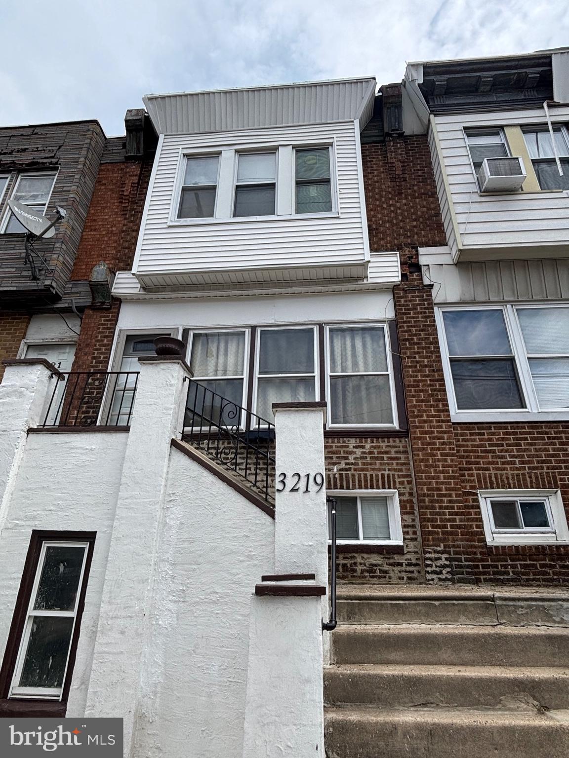 a front view of residential houses with stairs