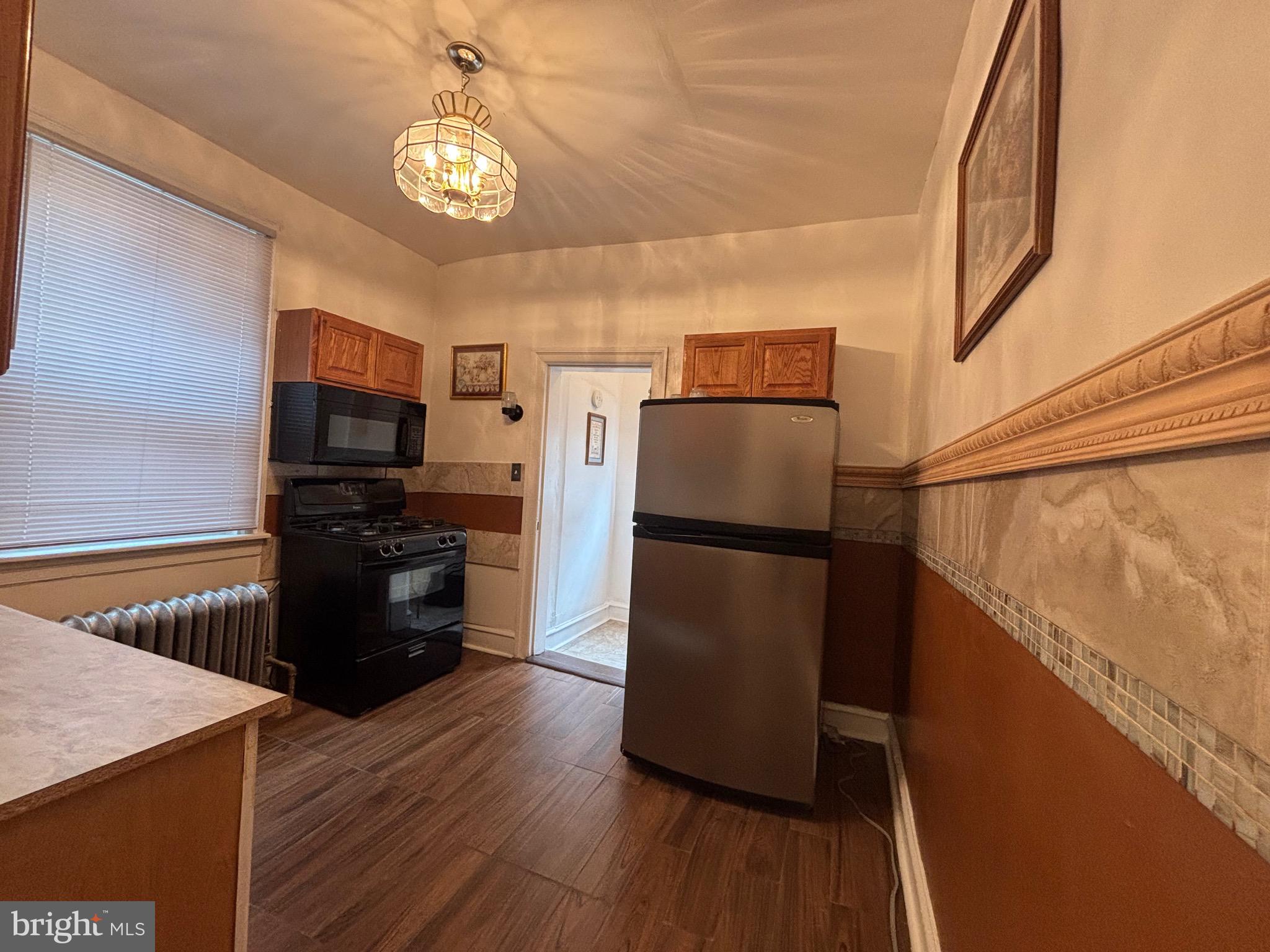 3219 North 29th Street Philadelphia, PA 19129 - Photo 16 of 48 a kitchen with a refrigerator and a stove top oven