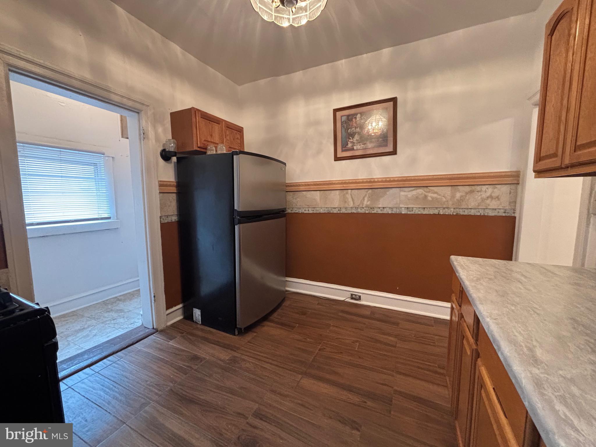 3219 North 29th Street Philadelphia, PA 19129 - Photo 17 of 48 a view of kitchen with stainless steel appliances wooden floor and a window