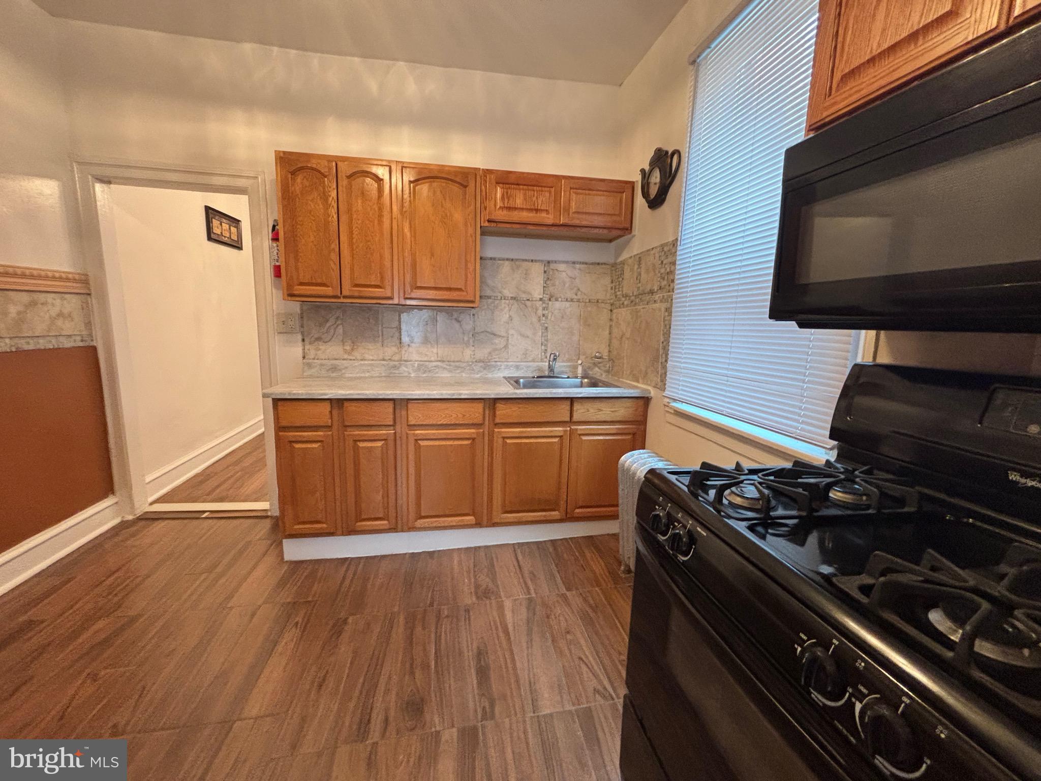 3219 North 29th Street Philadelphia, PA 19129 - Photo 18 of 48 a kitchen with a stove and a microwave