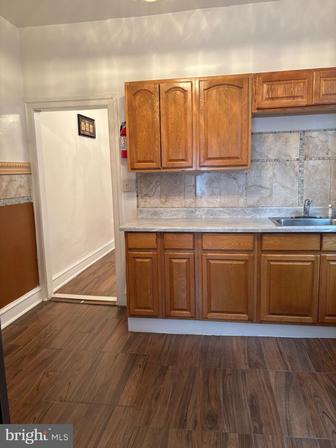 3219 North 29th Street Philadelphia, PA 19129 - Photo 19 of 48 a kitchen with granite countertop wooden floors and cabinets