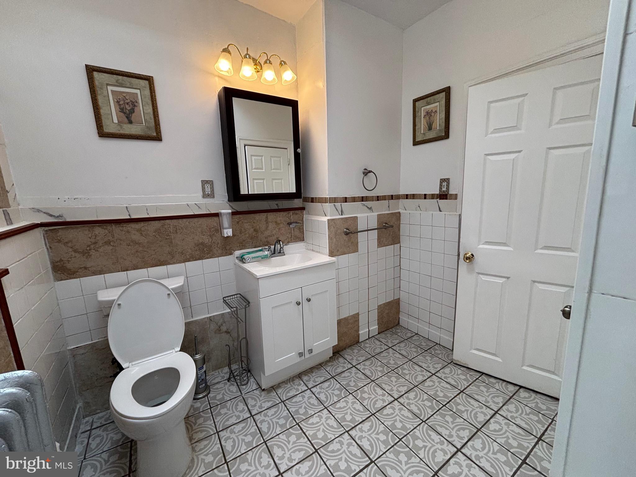 3219 North 29th Street Philadelphia, PA 19129 - Photo 37 of 48 a bathroom with a toilet sink and mirror