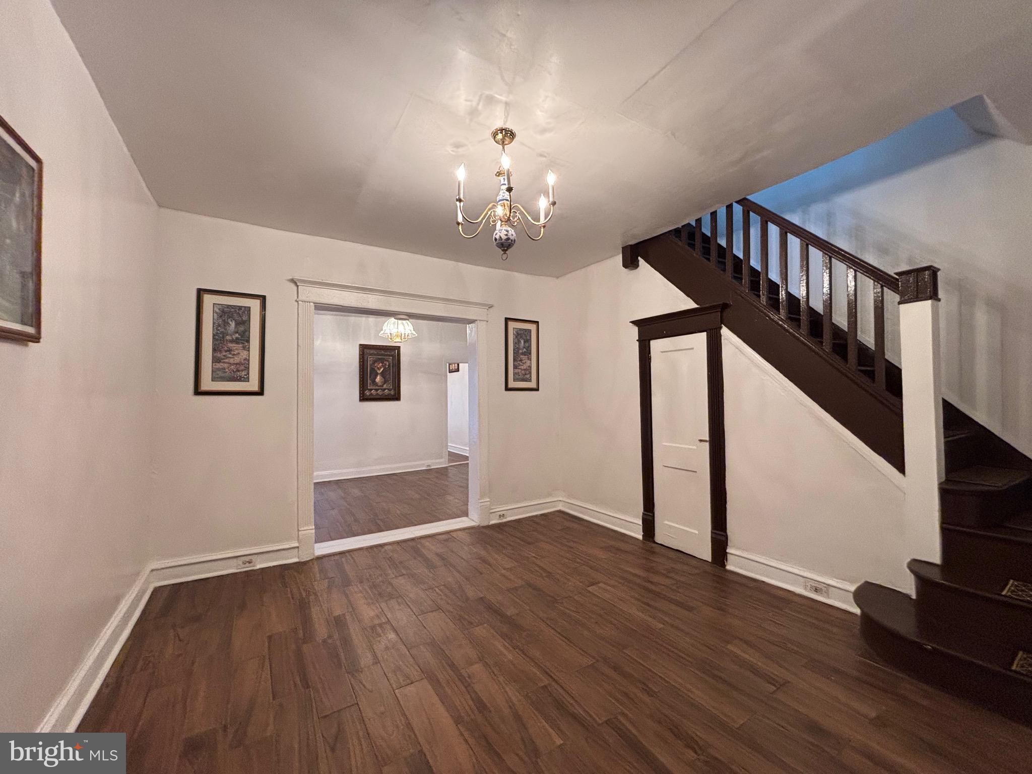 3219 North 29th Street Philadelphia, PA 19129 - Photo 7 of 48 a view of an empty room with wooden floor and stairs