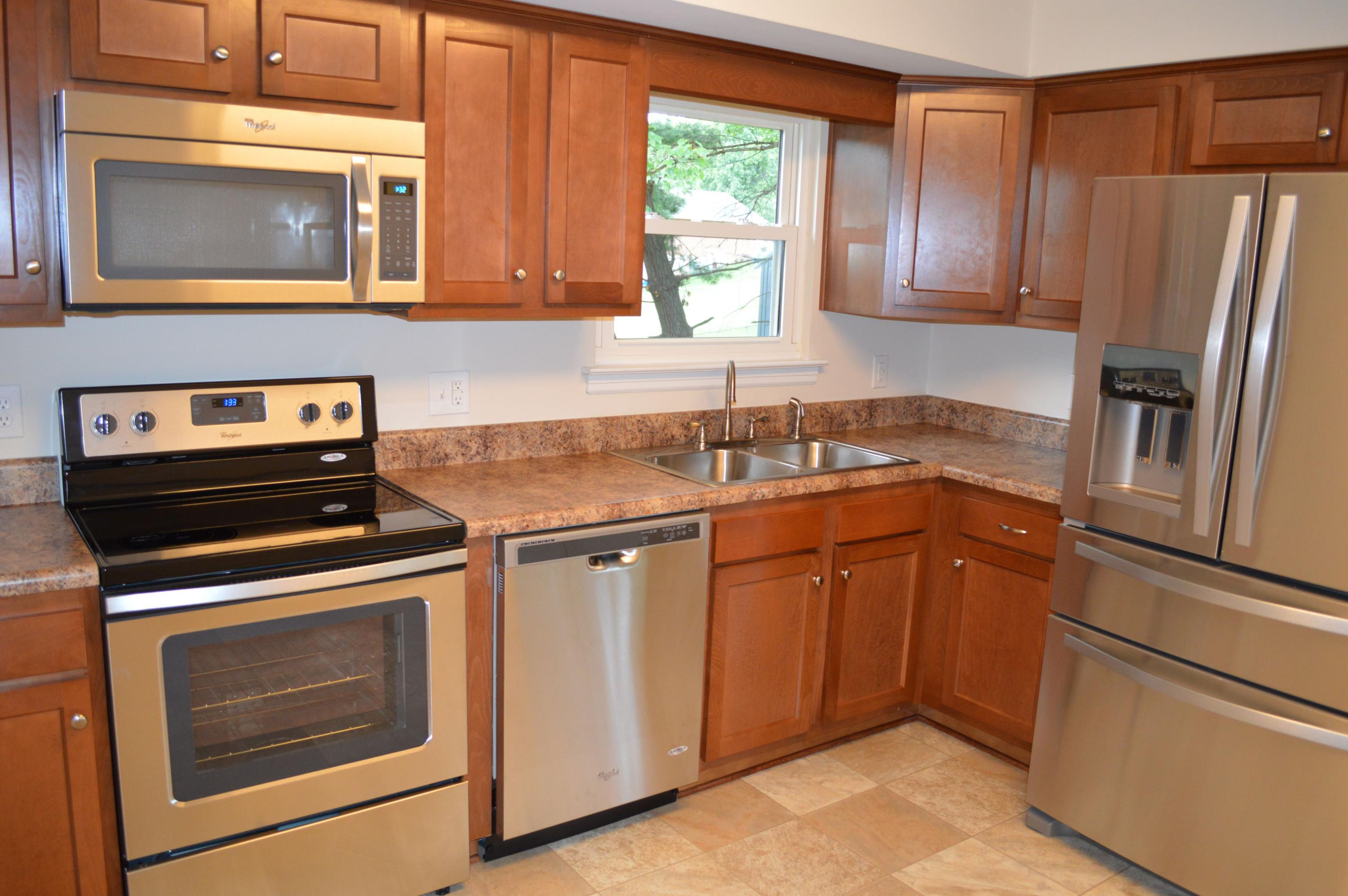 520 Olney Road Vinton, VA 24179 - Photo 8 of 29 a kitchen with granite countertop cabinets stainless steel appliances and a window