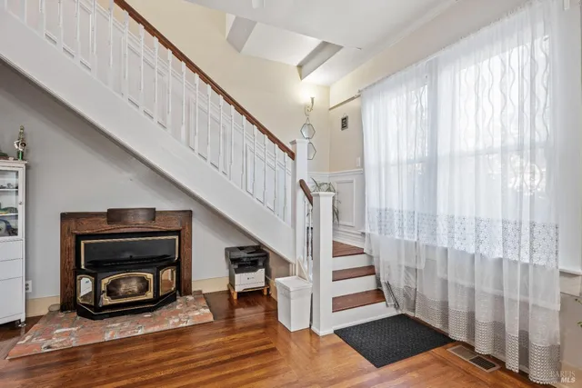 a view of entryway and hall with wooden floor