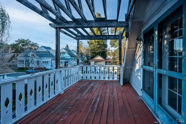 a view of a balcony with wooden floor