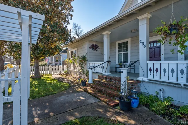 a view of a porch with chairs and backyard