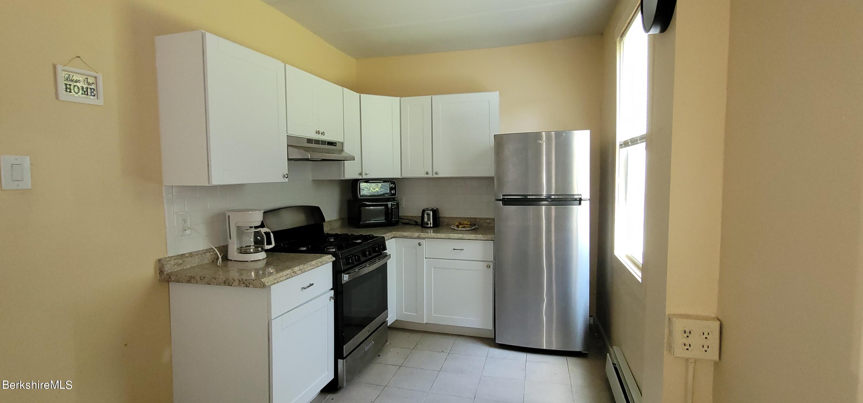 18 Grove Avenue Adams, MA 01220 - Photo 2 of 10 a kitchen with a refrigerator stove and sink