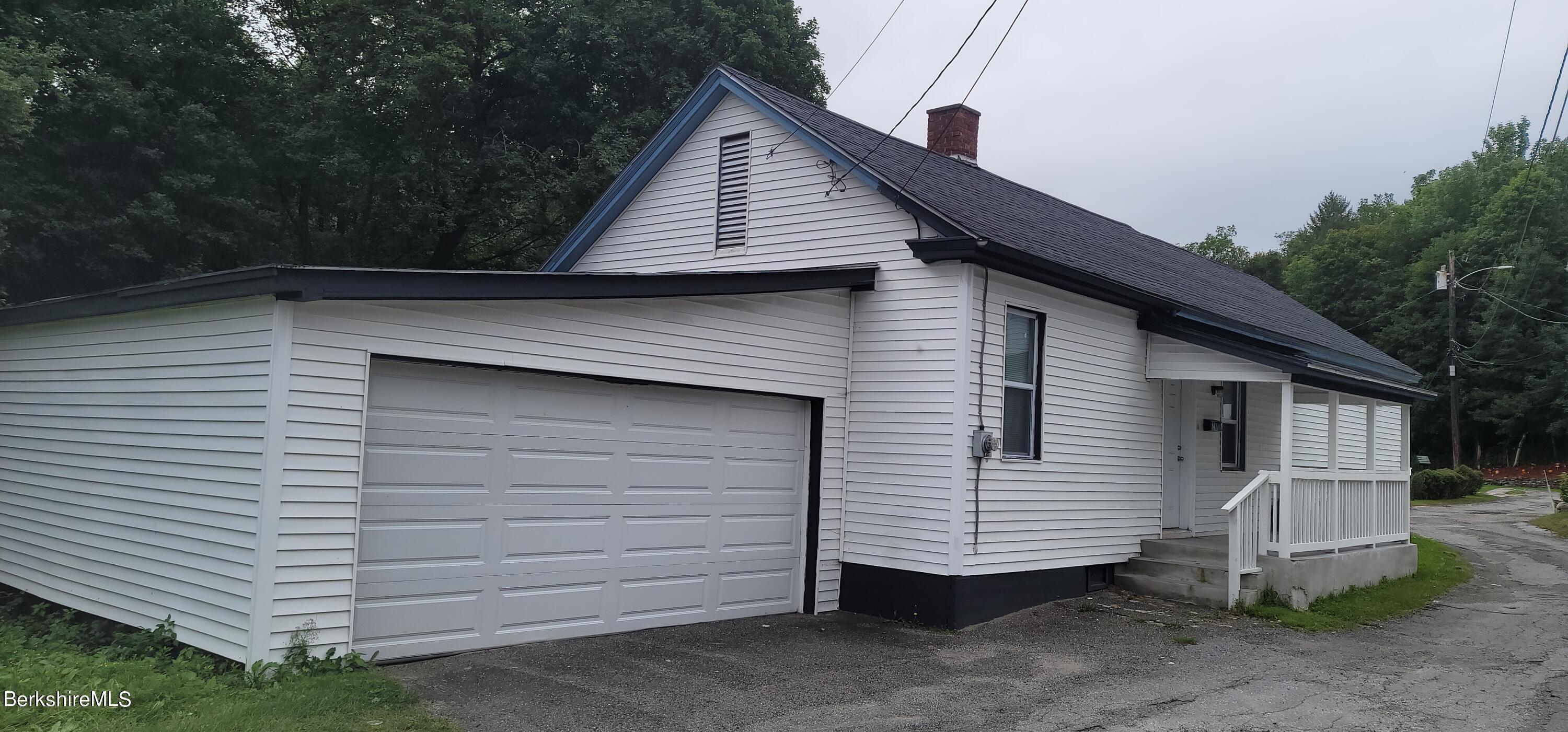 18 Grove Avenue Adams, MA 01220 - Photo 10 of 10 a view of a white house with a large window and wooden fence