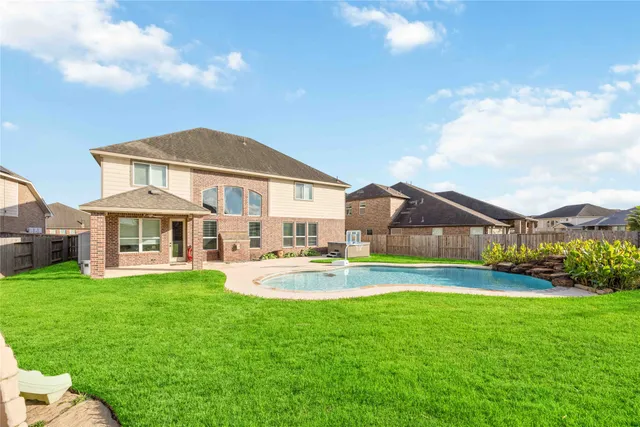 a view of a house with a yard and sitting area