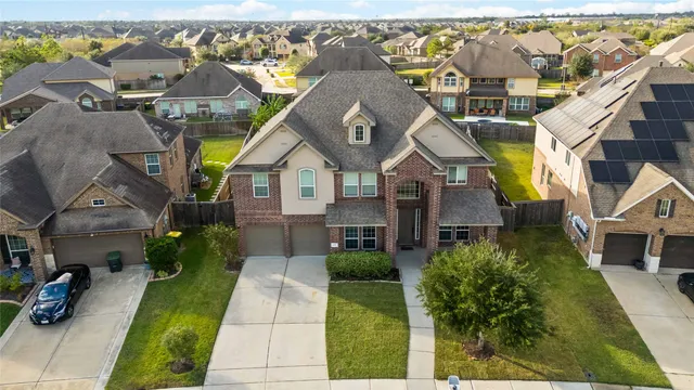 a aerial view of a house with a yard and potted plants