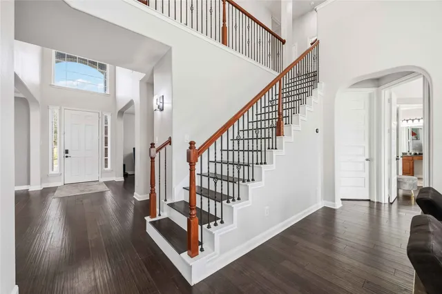 a view of entryway with wooden floor and stairs