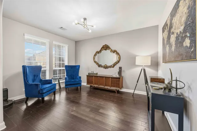 a living room with furniture piano and a wooden floor