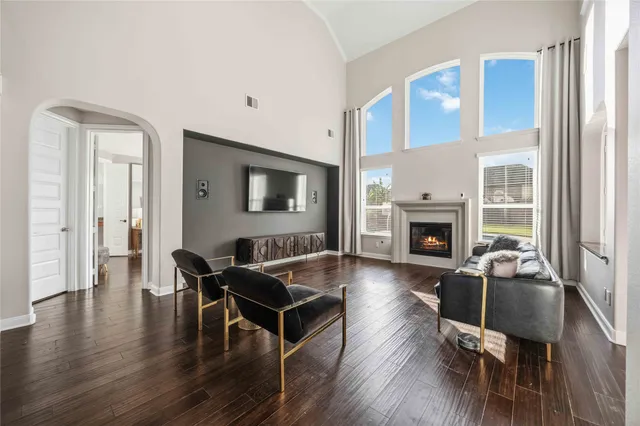 a living room with furniture wooden floor and a fireplace