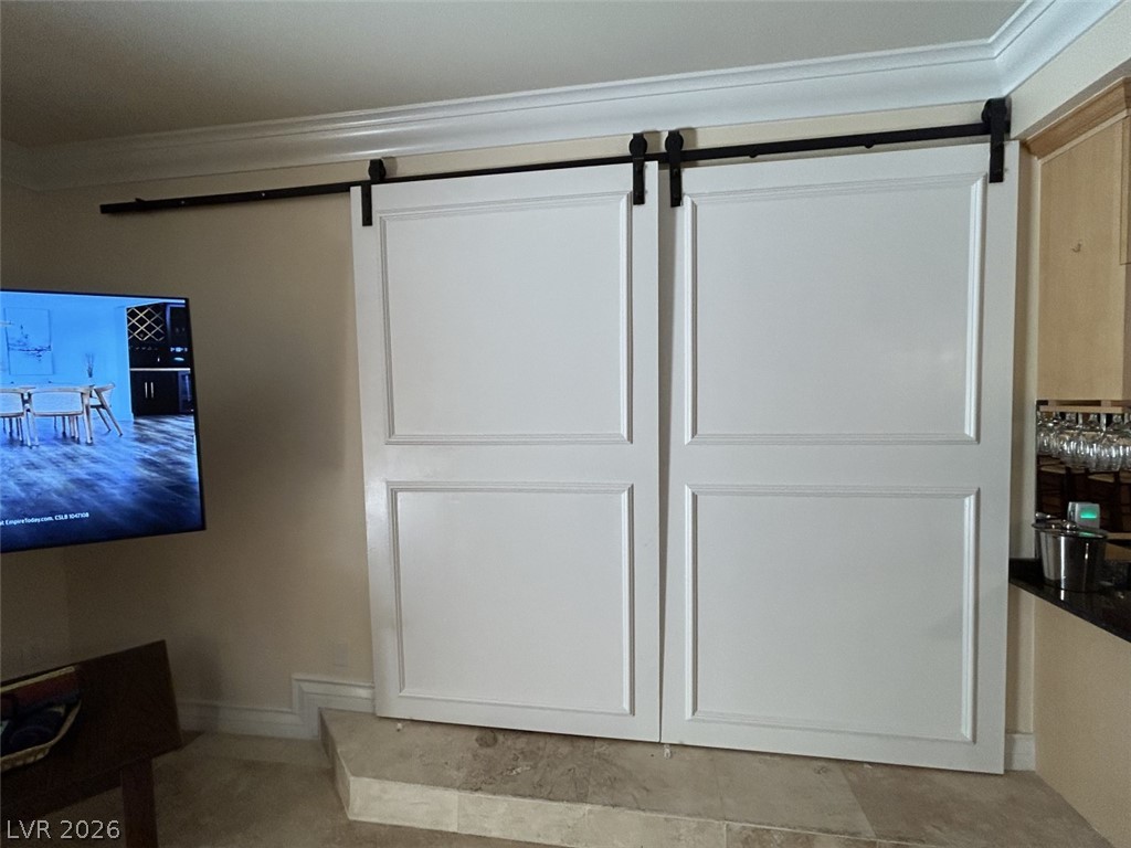 210 East Flamingo Road, Unit 137 Las Vegas, NV 89169 - Photo 11 of 32 Sliding barn doors elegantly conceal a discreet space within this interior.