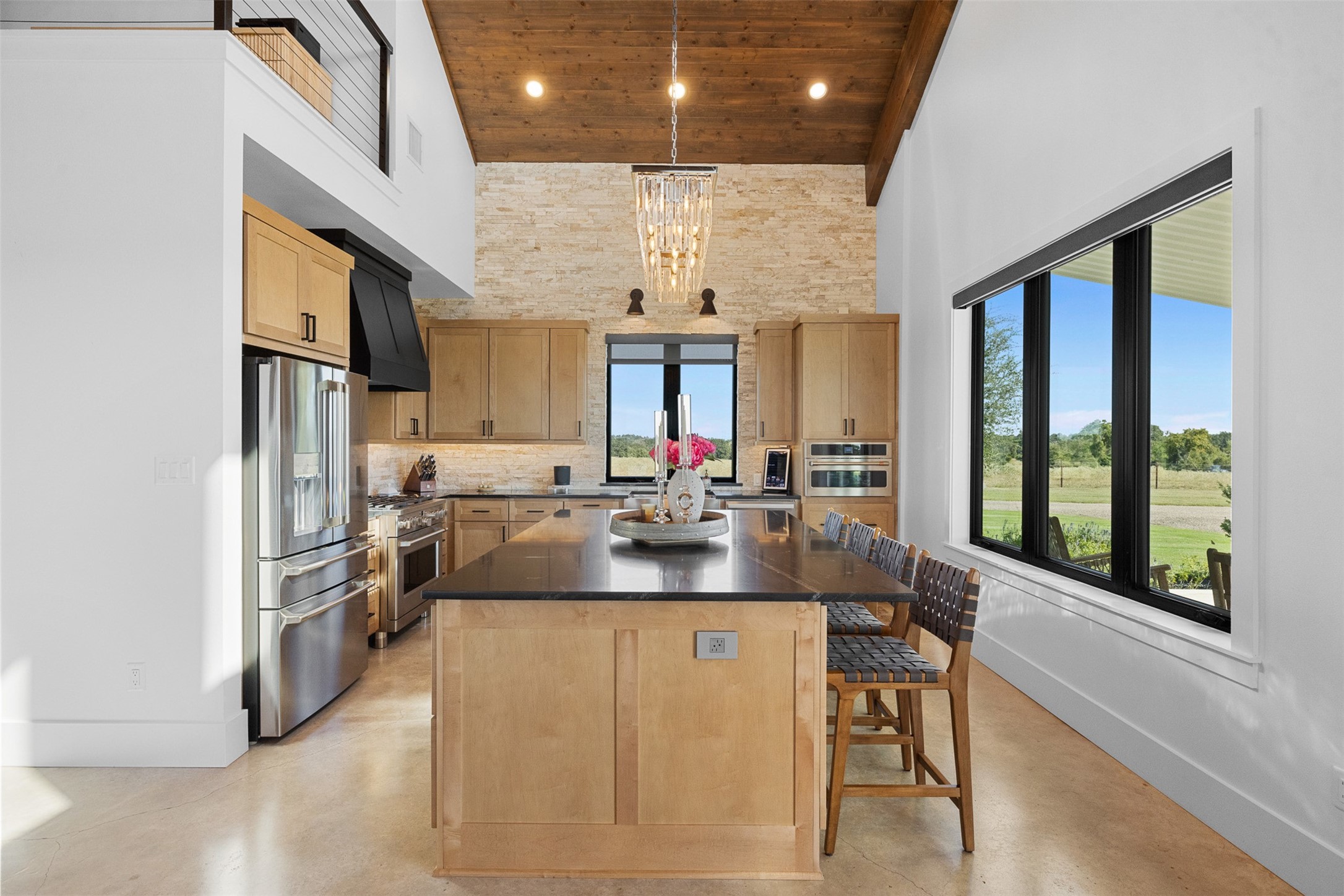 2134 Carter Road Bellville, TX 77418 - Photo 12 of 38 a kitchen with stainless steel appliances granite countertop a sink stove and refrigerator