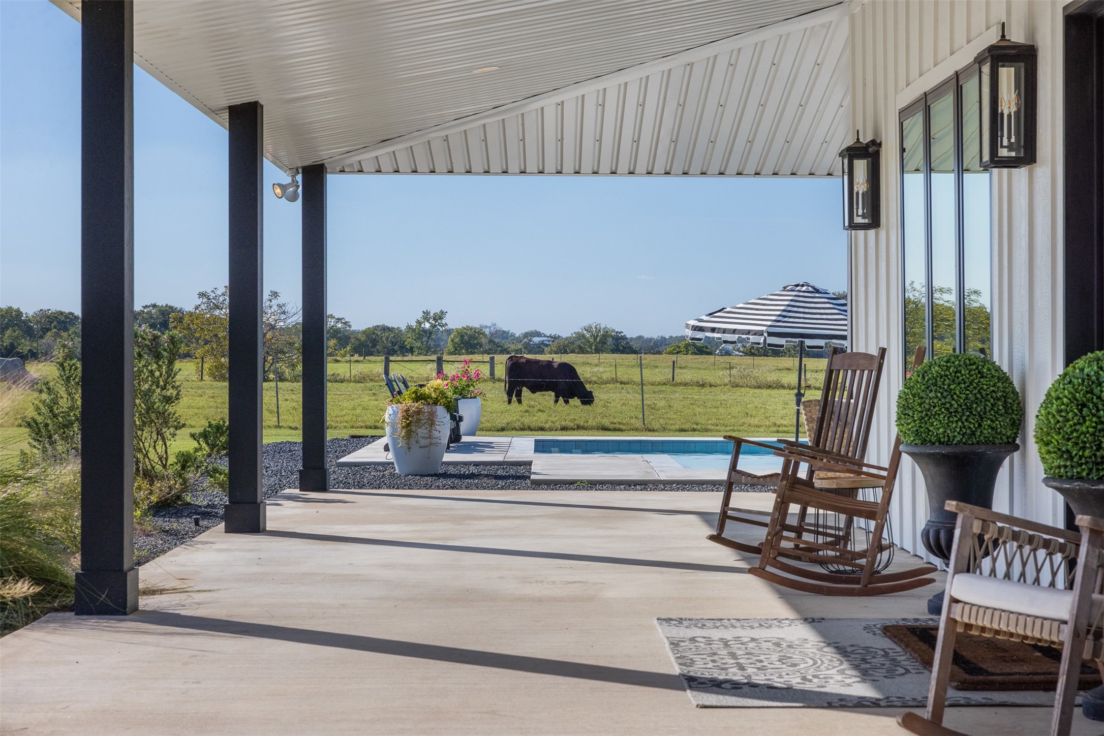 2134 Carter Road Bellville, TX 77418 - Photo 29 of 38 a swimming pool with outdoor seating outdoor seating and yard
