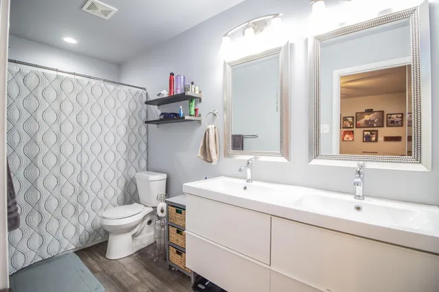 a bathroom with a sink toilet and a mirror
