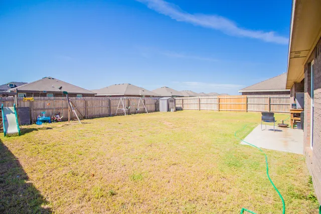 a swimming pool with trees in the background