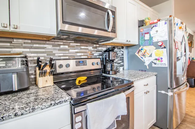 a kitchen with stainless steel appliances granite countertop a sink and dishwasher