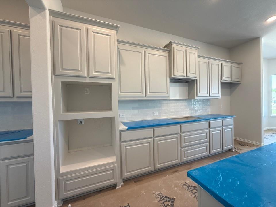 605 Tay Tay Way Springtown, TX 76082 - Photo 11 of 19 a kitchen with white cabinets and counter space