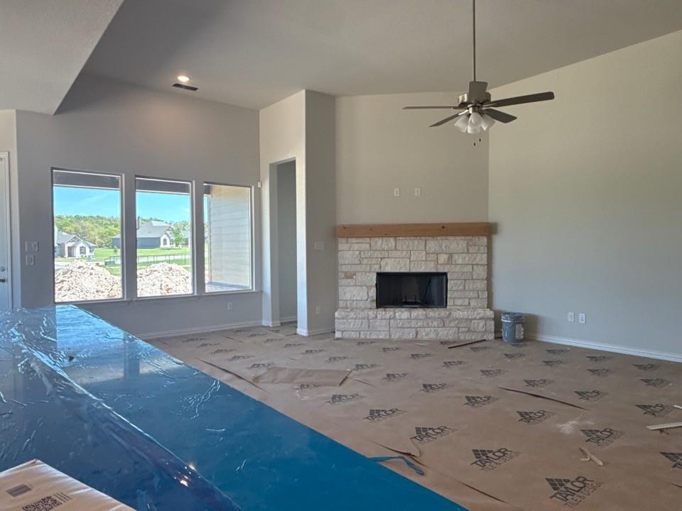 605 Tay Tay Way Springtown, TX 76082 - Photo 12 of 19 an empty room with a fireplace and fan