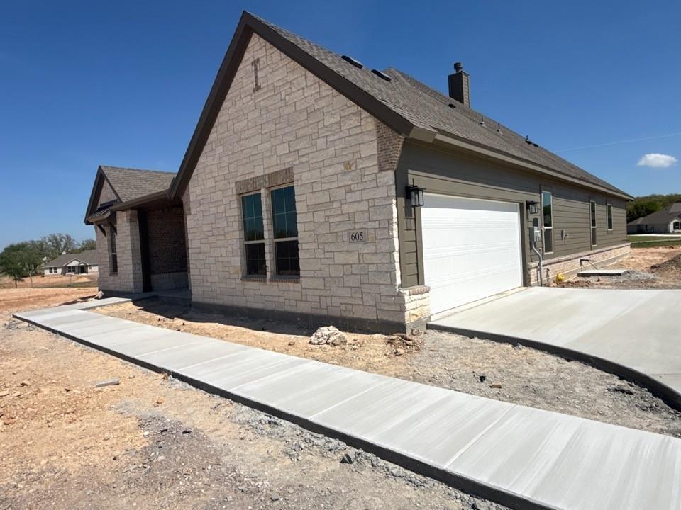 605 Tay Tay Way Springtown, TX 76082 - Photo 3 of 19 a view of a house with snow on the road