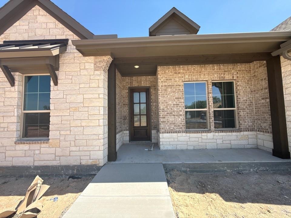 605 Tay Tay Way Springtown, TX 76082 - Photo 4 of 19 a front view of a house with a yard