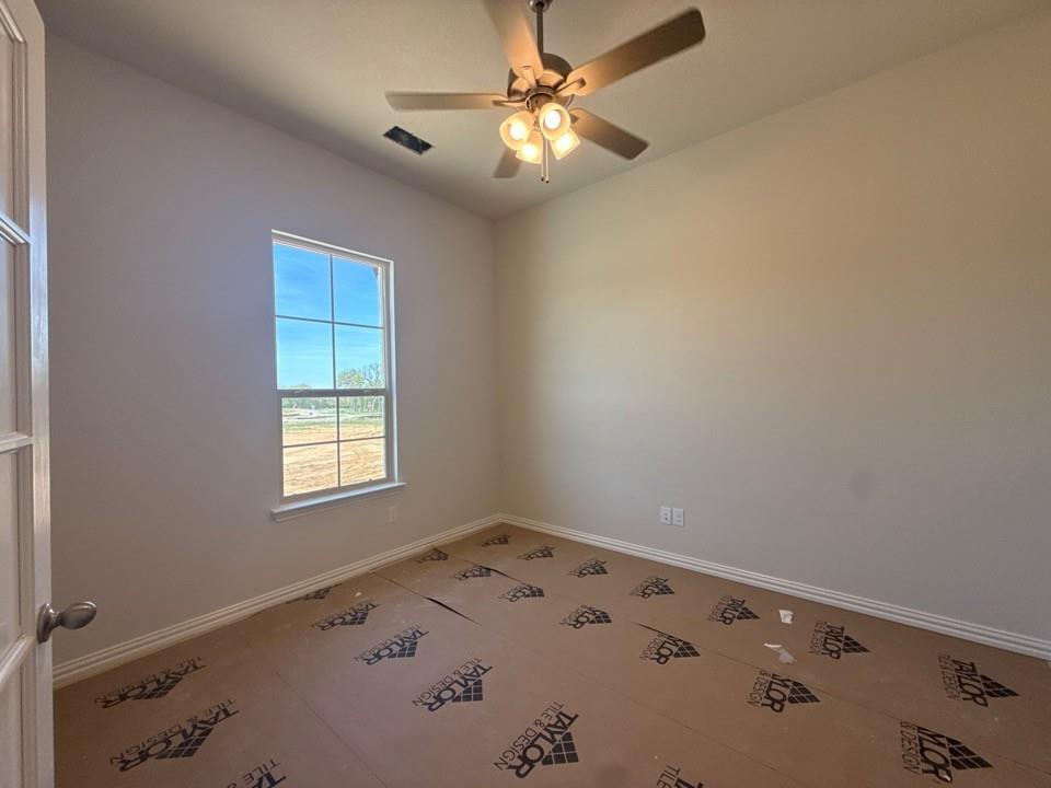 605 Tay Tay Way Springtown, TX 76082 - Photo 5 of 19 an empty room with a window and a fan