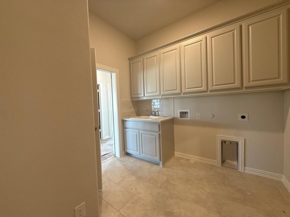 605 Tay Tay Way Springtown, TX 76082 - Photo 9 of 19 a kitchen with white cabinets and a sink