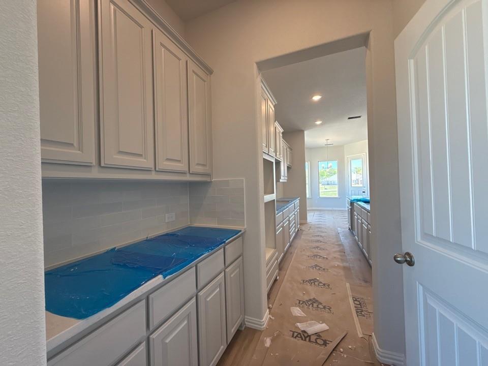 605 Tay Tay Way Springtown, TX 76082 - Photo 10 of 19 a view of a hallway with wooden floor and staircase