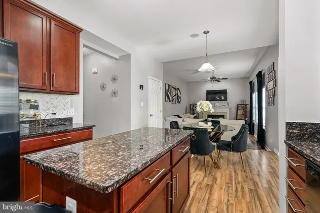 a kitchen with stainless steel appliances granite countertop sink stove and refrigerator