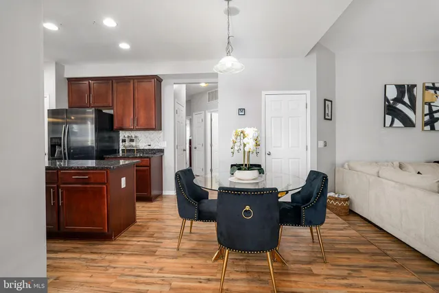 a kitchen with granite countertop a sink cabinets and stainless steel appliances