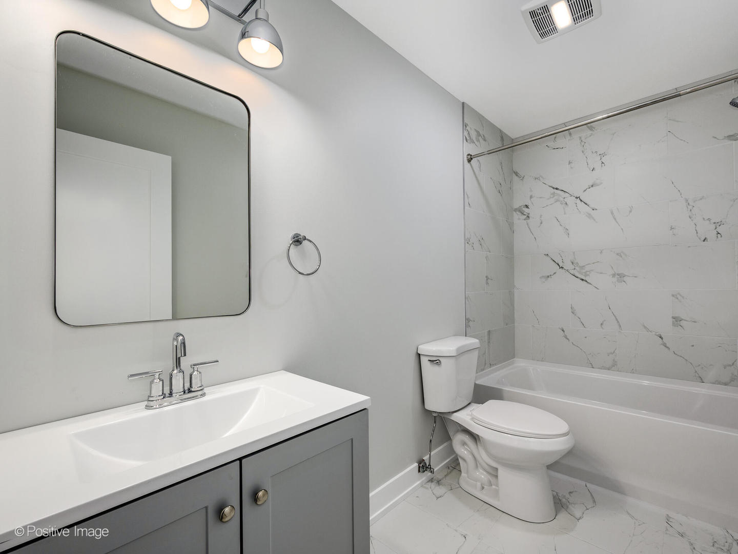 3944 South Indiana Avenue, Unit 1F Chicago, IL 60653 - Photo 11 of 12 a bathroom with a toilet sink a mirror and shower