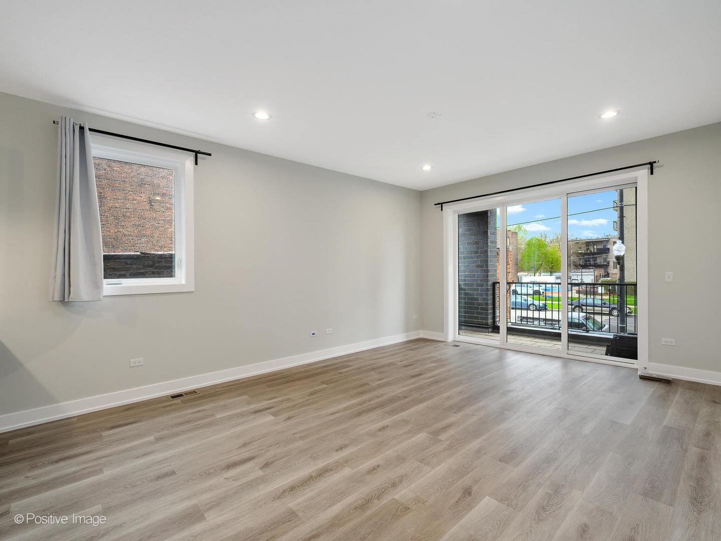 3944 South Indiana Avenue, Unit 1F Chicago, IL 60653 - Photo 5 of 12 a view of an empty room with wooden floor and a window
