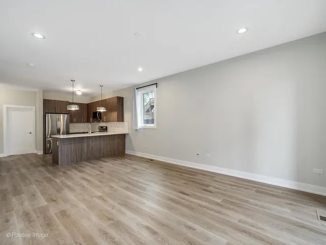 a view of kitchen and kitchen with microwave