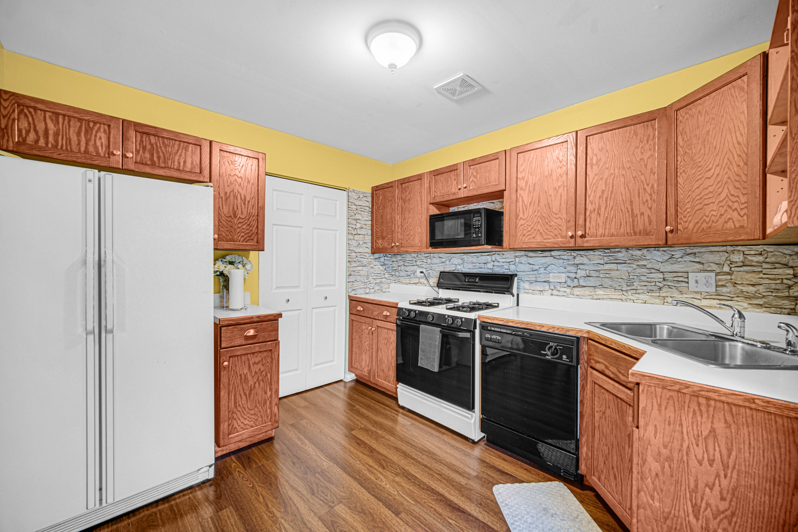 1326 Spring Valley Drive, Unit 1326 Carol Stream, IL 60188 - Photo 7 of 18 a kitchen with stainless steel appliances granite countertop a refrigerator stove and sink