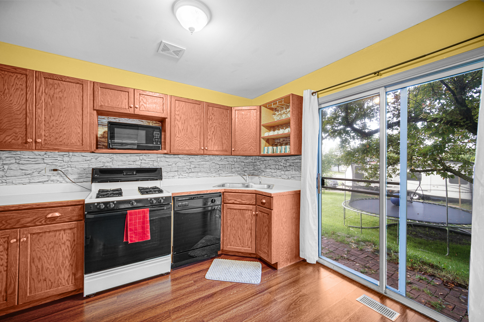 1326 Spring Valley Drive, Unit 1326 Carol Stream, IL 60188 - Photo 8 of 18 a kitchen with stainless steel appliances granite countertop a stove and a wooden cabinets