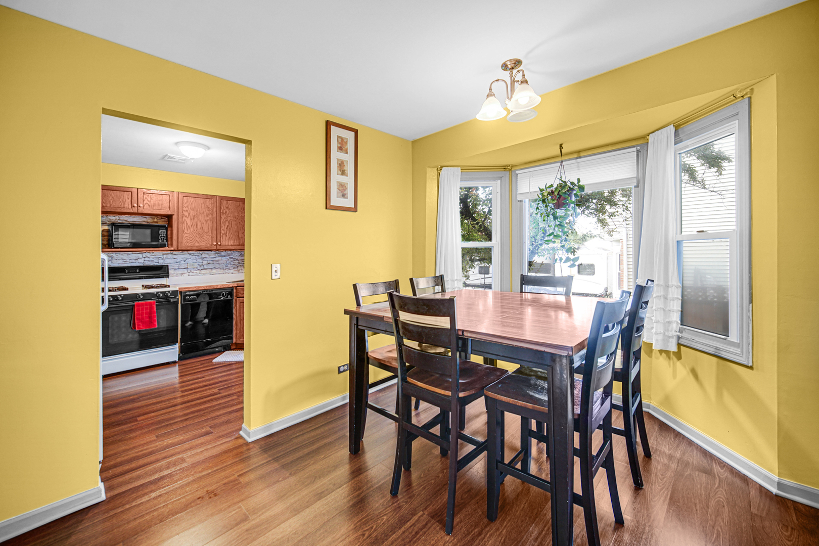 1326 Spring Valley Drive, Unit 1326 Carol Stream, IL 60188 - Photo 9 of 18 a view of a dining room with furniture and wooden floor