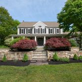a front view of house with yard and green space