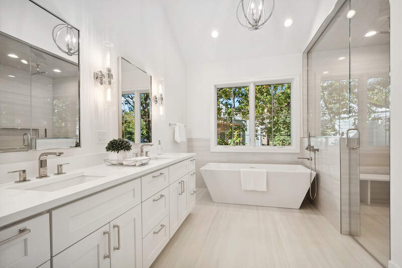 1209 Maple Avenue Wilmette, IL 60091 - Photo 27 of 28 a bathroom with a double vanity sink a large mirror and a bathtub