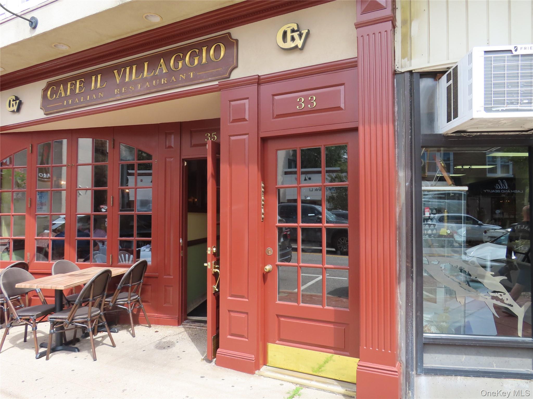 a view of a cafe with a couple of people seating