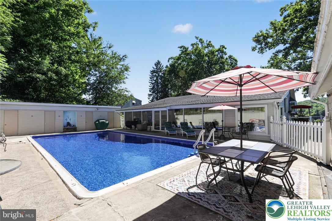 740 Public Road Bethlehem, PA 18015 - Photo 7 of 40 An inviting backyard oasis offers a sparkling in-ground pool and ample patio space for outdoor enjoyment.